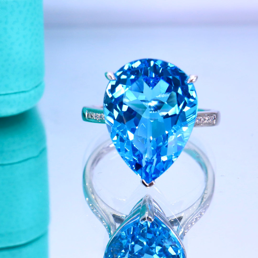 Elegant Simplicity: Swiss Blue Topaz Ring with 18k Gold and Diamond Accent