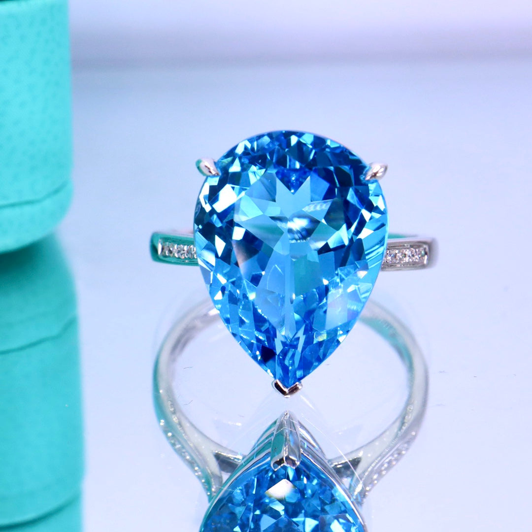 Elegant Simplicity: Swiss Blue Topaz Ring with 18k Gold and Diamond Accent